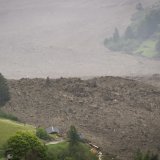 A large avalanche with a mixture of ice, rock, snow and water reach the valley floor is pictured in Wiler after the Birch glacier collapsing above Blatten, Switzerland, Wednesday, May 28, 2025. A large part of the village of Blatten in the Valais Loetschental was buried under the masses of ice, mud and rock. Numerous houses were destroyed, but no people were harmed. On the Kleiner Nesthorn above Blatten, several million cubic metres of rock collapsed between 19 and 28 May. A nine million tonne cone of rubble formed on the Birch Glacier below, which broke on 28 May 2025. (KEYSTONE/Jean-Christophe Bott)